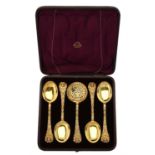 A cased set of four Victorian silver gilt fruit spoons and a sifting spoon by Henry William Curry