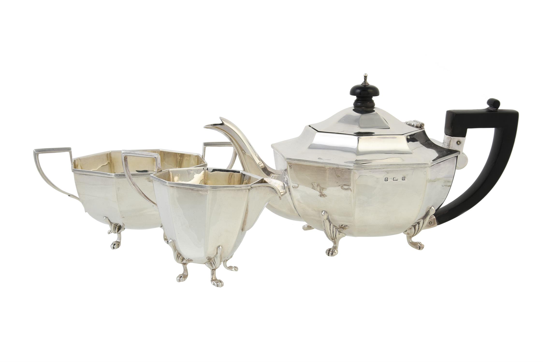 A silver octagonal three piece tea set by Barrett & Thompson