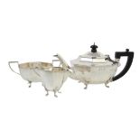 A silver octagonal three piece tea set by Barrett & Thompson