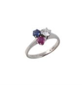 A diamond, sapphire and ruby three stone cluster ring