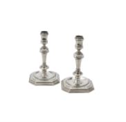 A pair of cast silver candlesticks by Spink & Son