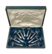 A cased set of twelve French silver lamb shank holders by Louis Ravinet & Charles Denfert