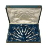 A cased set of twelve French silver lamb shank holders by Louis Ravinet & Charles Denfert