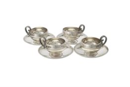 A set of four French silver cups and saucers