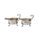 A pair of George II silver shaped oval sauce boats