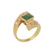 An emerald and diamond crossover ring