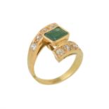 An emerald and diamond crossover ring