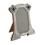 An Art Nouveau silver mounted and enamel shaped rectangular photo frame by William Hutton & Sons Ltd