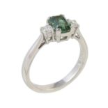 A green tourmaline and diamond three stone ring