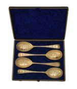 A cased set of four George III silver gilt Old English pattern berry spoons
