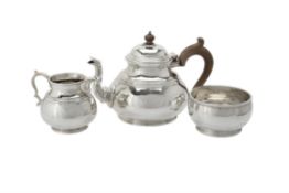 A silver circular baluster three piece tea set by Richard Comyns