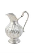 A continental silver coloured fluted baluster water jug