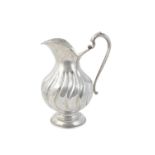 A continental silver coloured fluted baluster water jug