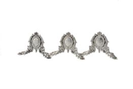 A set of three French silver coloured menu holders