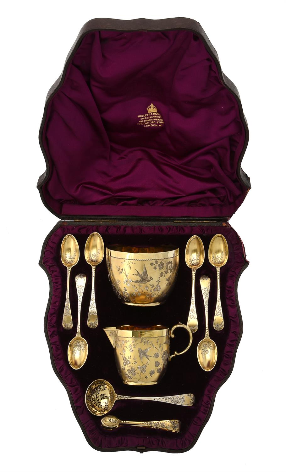 A Victorian silver gilt cream jug, sugar bowl, sifting spoon, six tea spoons and a pair of sugar ton