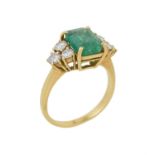 An emerald and diamond seven stone ring