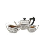 An Edwardian silver oblong baluster three piece tea set by The Alexander Clark Manufacturing Co.