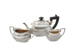 An Edwardian silver oblong baluster three piece tea set by The Alexander Clark Manufacturing Co.