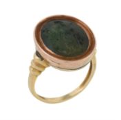 An antique carved hydrogrossular garnet intaglio of Athena in later composite ring setting