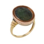 An antique carved hydrogrossular garnet intaglio of Athena in later composite ring setting