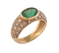 A diamond and emerald dress ring