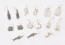 A collection of silver coloured earrings