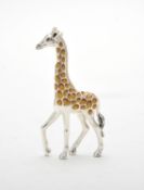 A silver coloured and enamel model of a giraffe