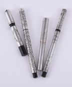 Four silver coloured fountain pens