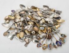 A collection of continental silver, silver coloured, silver gilt and enamel souvenir spoons