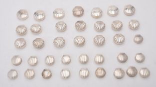 A collection of silver shell shaped pill boxes