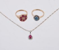 A 9 carat gold ruby and diamond flower head cluster ring