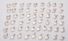 A collection of silver heart shaped scent bottles