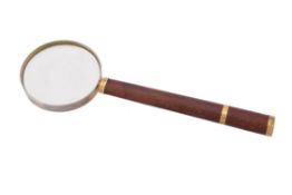 A leather and gold mounted magnifying glass