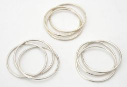 A collection of silver coloured triple bangles