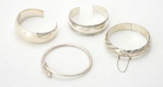 A collection of silver and silver coloured bangles