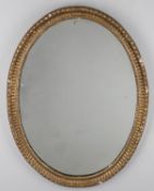 A George III oval giltwood mirror