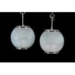 A pair of modern glass globular frosted glass light fittings