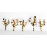 A set of five gilt metal twin light wall lights in Louis XV style