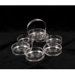 A silver mounted glass hors d'oeuvres dish with seven plain circular shallow dishes