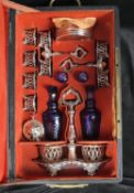 A 19th century French leather cased traveling silver and blue glass cruets and condiments set