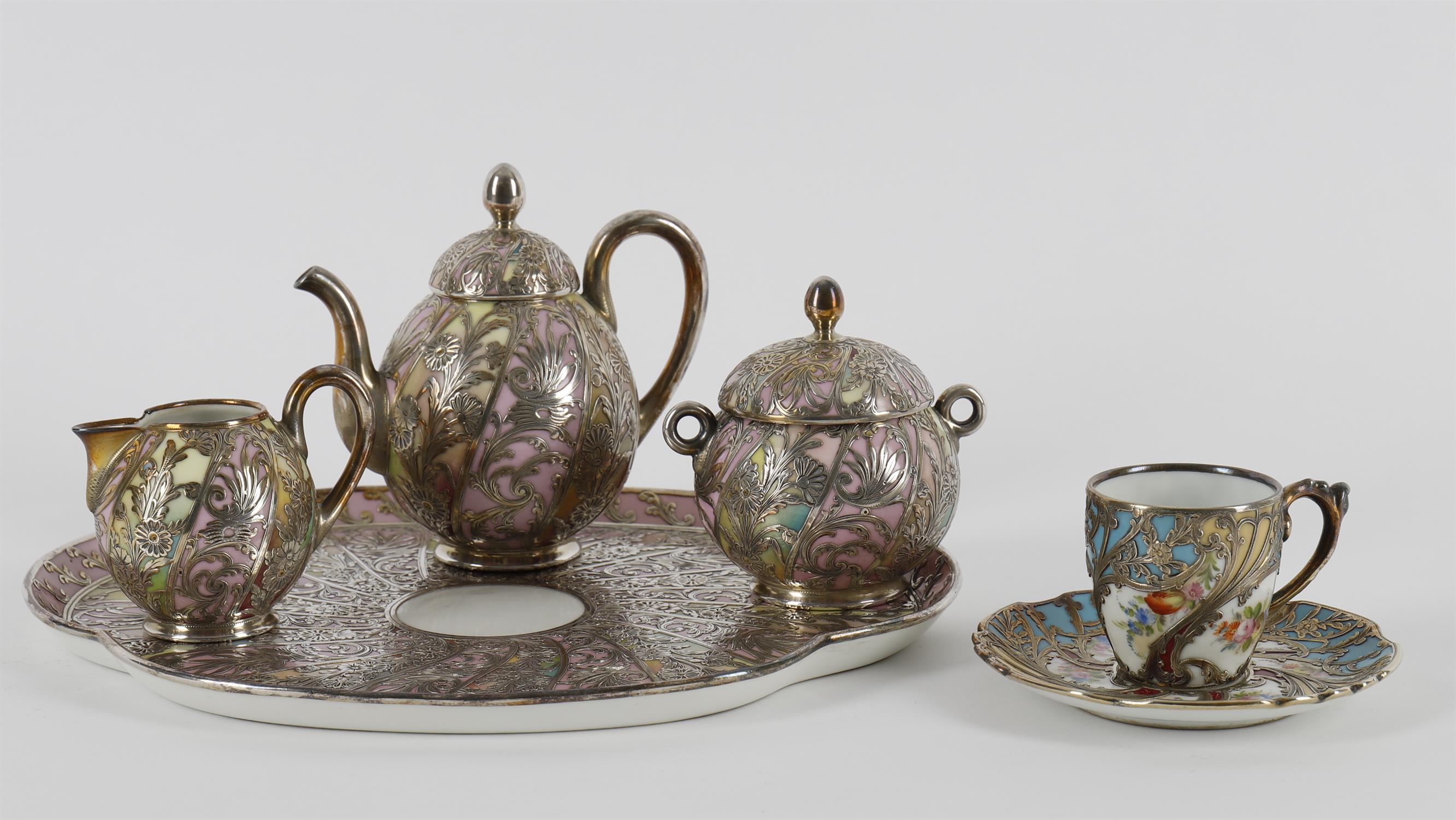 A matched Limoges porcelain and white metal overlaid five piece cabaret set