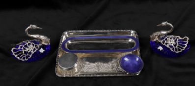 A pair of silver mounted blue glass sweet dishes of swan form