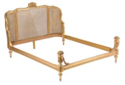 An early/mid-20th century French carved giltwood bed