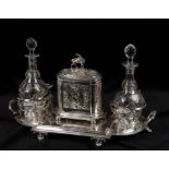 An early 20th century silver plated decanter and biscuit box stand