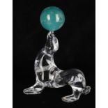Daum- a glass figure of a seal balancing a green glass ball
