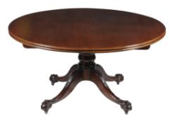 A large circular mahogany breakfast table in the mid-18th century style