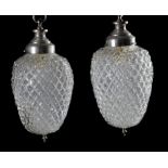 A pair of modern chrome and glass ceiling lights