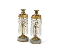 A pair of gilt metal, marble mounted and glass hung lustre candlesticks