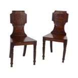 A pair of Regency mahogany hall chairs