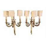 A pair of gilt metal three branch wall lights in Louis XVI style